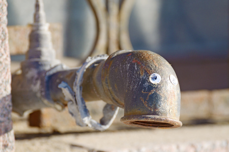Pipe for water supply.It is located in the wall of the house on the street.