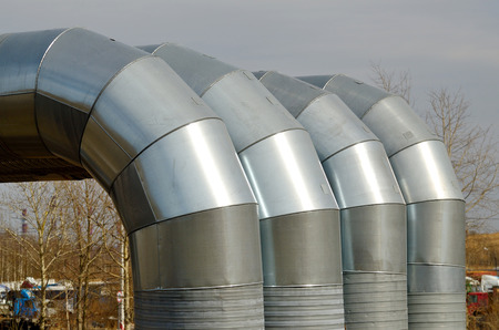 heating main going to the city from the thermal station.Hot water flows through these pipes.の写真素材