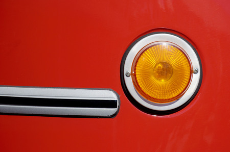 Round headlight on the bus..In the dark, the headlight illuminates the road.の写真素材