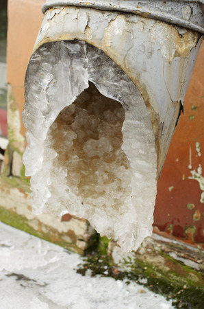 Drainpipe on the wall of the building.The water in it had frozen and formed icicles.の写真素材