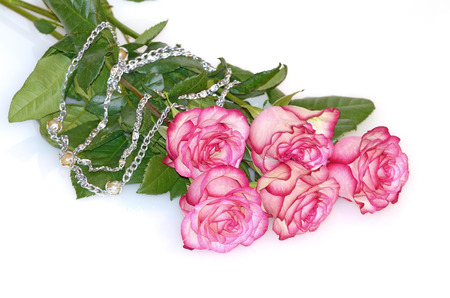 Bouquet of five roses.Nearby is the women's necklace.の写真素材