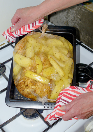 Baked potatoes with chicken.The dish is prepared in the oven gas stove.の写真素材