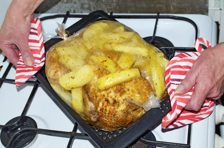 Baked potatoes with chicken.The dish is prepared in the oven gas stove.の写真素材