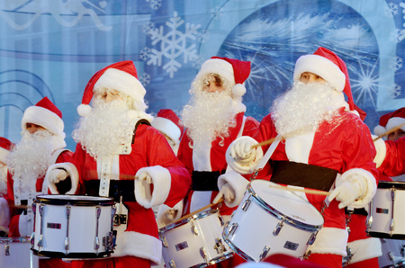 Saint-Petersburg.Russia.December.22.2018.Musicians in the form of Santa Claus.On Christmas eve give a concert in front of the audience.They play drums.Perform at the Palace square.のeditorial素材
