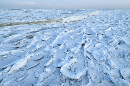 The Bay is covered with ice.Frost had formed from the snow a beautiful texture.の写真素材