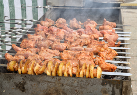Cooking meat dishes.shashlik is prepared on coals.の写真素材