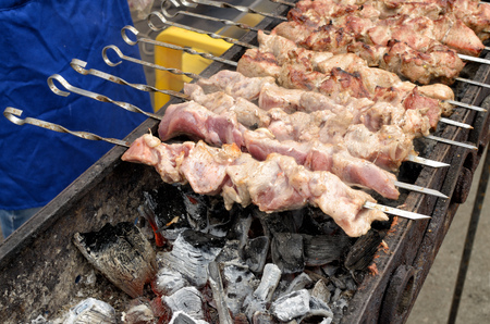 Cooking meat dishes.shashlik is prepared on coals.の写真素材