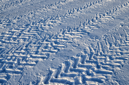 Car tire tread on snow.They create a special pattern.の写真素材