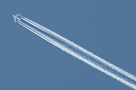 the aircraft is in high speed flying in the sky,leaving a trail.の写真素材