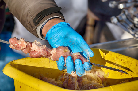 Stringing meat on a skewer.Preparation of meat for barbecue.の写真素材