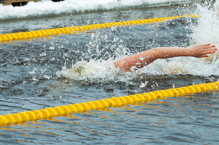 Lovers of winter swimming.Swimmer swims in the pool.He swims the distance at speed.の写真素材