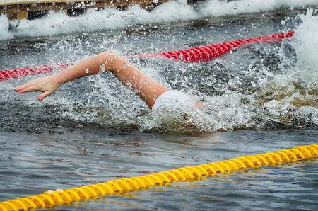 Lovers of winter swimming.Swimmer swims in the pool.He swims the distance at speed.の写真素材
