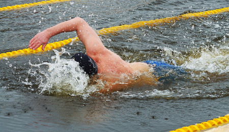 Lovers of winter swimming.Swimmer swims in the pool.He swims the distance at speed.の写真素材