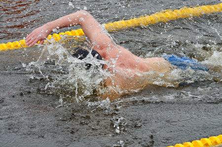 Lovers of winter swimming.Swimmer swims in the pool.He swims the distance at speed.の写真素材