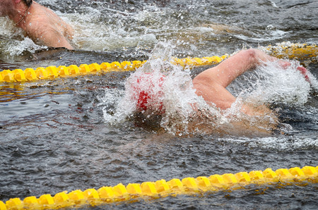 Lovers of winter swimming.Swimmer swims in the pool.He swims the distance at speed.の写真素材