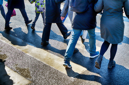 Pedestrian crossing across the road.At this point, people cross the road at a green traffic light.の写真素材