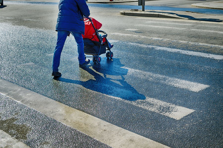 Pedestrian crossing across the road.At this point, people cross the road at a green traffic light.の写真素材