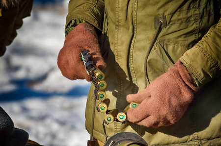 ammunition for the machine gun.The soldier is preparing for combat.