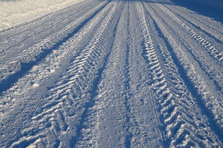 Car tire tread on snow.They create a special pattern.の写真素材