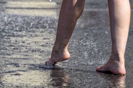 Walk barefoot in the rain through the puddles.It is pleasant and healthy.の写真素材