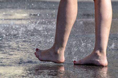 Walk barefoot in the rain through the puddles.It is pleasant and healthy.の写真素材