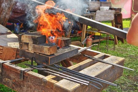 the blacksmith is a master of metal processing.He forges hot metal, and makes products from it.の写真素材
