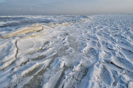 The Bay is covered with ice.Frost had formed from the snow a beautiful texture.の写真素材