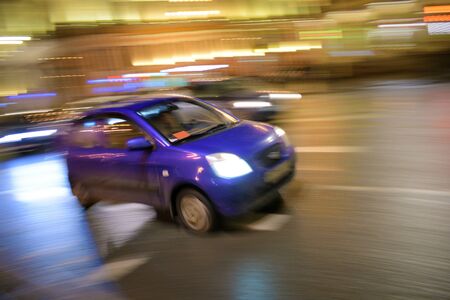 High-speed car driving.On the streets of the city glow electric lights.