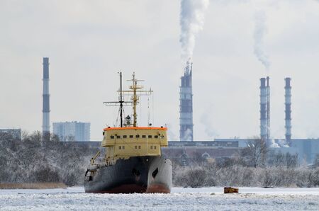 The water area of the port in winter.The water in the bay is covered with ice.の写真素材