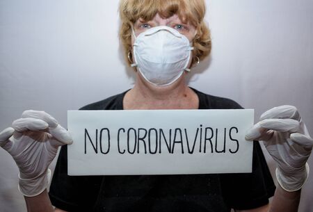 Remedies for coronavirus Covid-19.This is a mask on the face and gloves on the hands.の写真素材