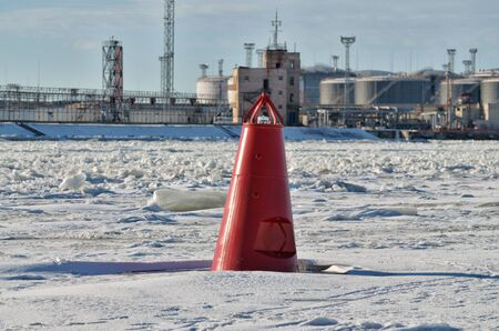 Red buoy on the river.This ensures the safety of the movement of ships.