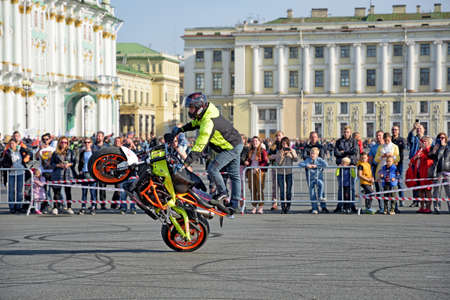 Saint Petersburg, Russia. September 26.2020.A biker festival is taking place. a biker demonstrates difficult and dangerous stunts on his motorcycle.This underlines his mastery of technique.のeditorial素材