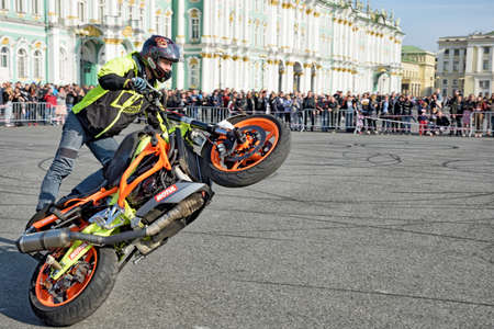 Saint Petersburg, Russia. September 26.2020.A biker festival is taking place. a biker demonstrates difficult and dangerous stunts on his motorcycle.This underlines his mastery of technique.のeditorial素材