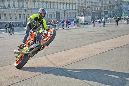 Saint Petersburg. Russia. September 26.2020.A biker festival is taking place. a biker demonstrates difficult and dangerous stunts on his motorcycle.This underlines his mastery of technique.のeditorial素材