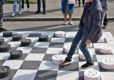 Russia, Saint Petersburg, September 20, 2020.Children play checkers on a large playing field. The...