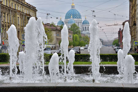 In the summer, fountains are turned on in the city.It is cool around them in hot weather.の写真素材