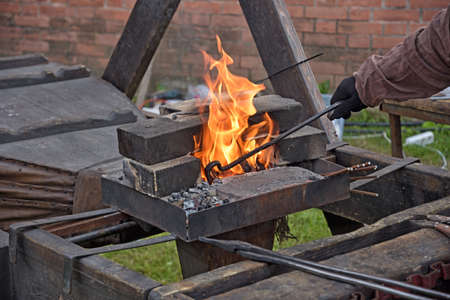 blacksmiths work with metal, heating it in a fire.this is hard work.の写真素材