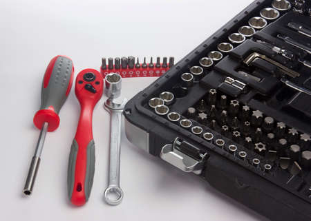 Keys and a screwdriver near the box with tools