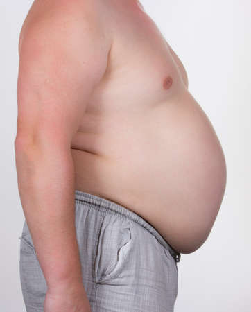 Plump man standing sideways on a white backgroundの写真素材