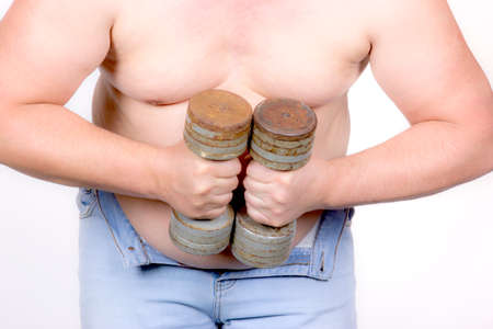 Full charging man engaged with dumbbells on a white background morningの写真素材