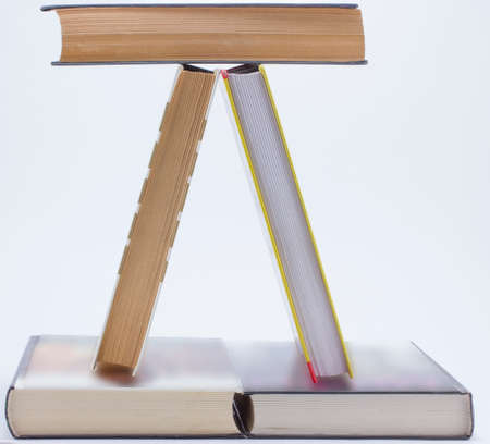 Books letter pyramid built on a gray backgroundの写真素材