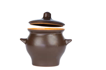Clay pot for cooking with a raised lid carved white background.の写真素材