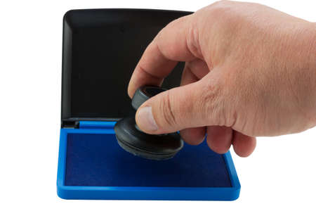 Hand with stamp and pad for stamps