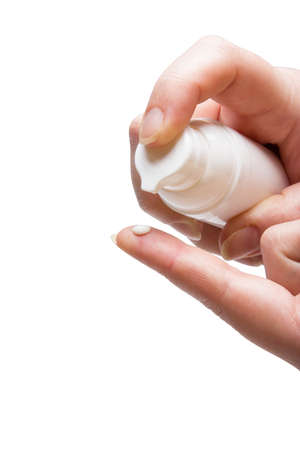 Cream on a woman's finger white isolated on white background.の写真素材