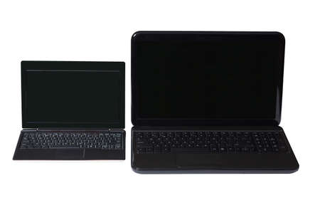 Netbook and notebook on a white background with black screen and keyboard.の写真素材