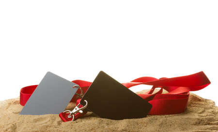 Card in the sand, black and gray in color with white background for cutting.