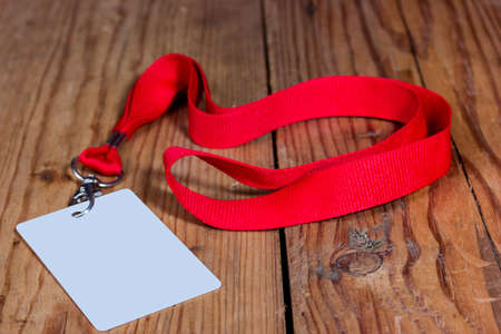 Badge on a wooden background with a red ribbonの写真素材