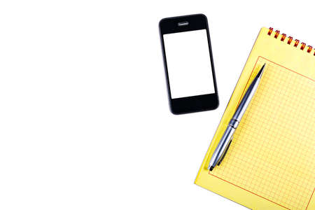 Notepad with pen, isolated on a white background with a phone.の写真素材