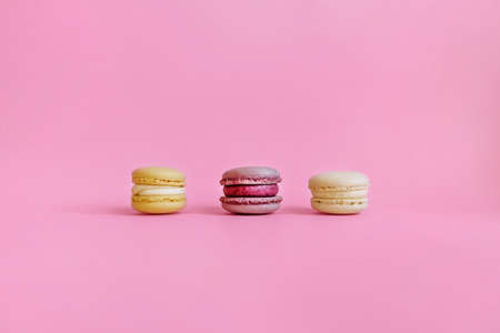 The view from the top. Purple background with space for your text and three colored macaroons.の写真素材