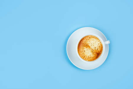 One morning Cup of espresso on a blue background, space for your text. Flat lay, top view.の写真素材